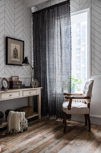 Close-up of black checkered cotton linen curtain featuring elegant fringe trim details