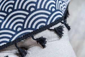 Detailed view of navy blue Seigaiha pattern print with elegant black tassel fringe