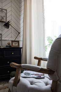 Detail of beige linen curtain featuring intricate white lace crochet trim for a boho home style