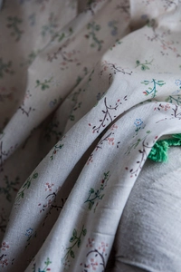 Detail of floral print green tassel curtain fabric with cotton linen texture