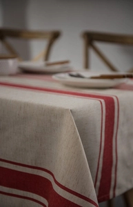 Detail of red striped linen tablecloth showing natural fiber texture and warm beige tones
