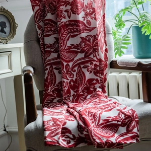 Baroque red floral cotton linen curtain draped over a chair in a classic living room