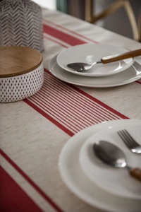 Detail of red striped linen table runner with rustic cotton texture and premium stitching