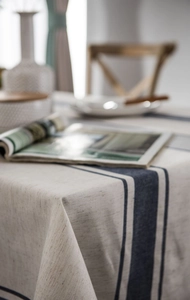 Close-up detail of woven linen cotton tablecloth with navy stripes and natural fabric texture