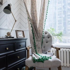 Floral cotton linen curtain with green tassels in a cozy natural home setting