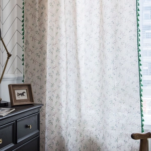 Floral print cotton linen curtain with green tassels in a cozy vintage cottage style