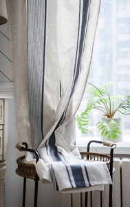 Detail shot of navy blue stripes on linen fabric for kitchen curtains with woven texture