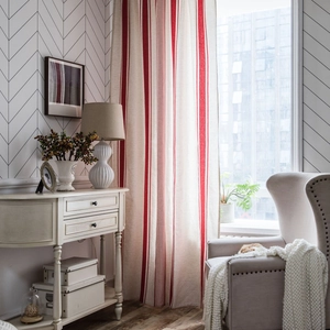Classic red and white striped kitchen cafe curtain in a cozy American rustic living room