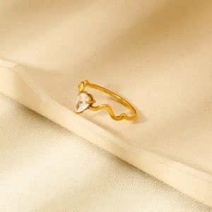 Detailed view of wave-shaped 18K gold plated ring with a teardrop zircon stone