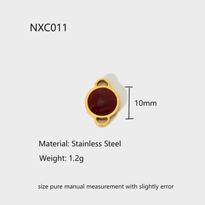 Detail view of a 10mm stainless steel pendant with a red stone and gold-plated finish