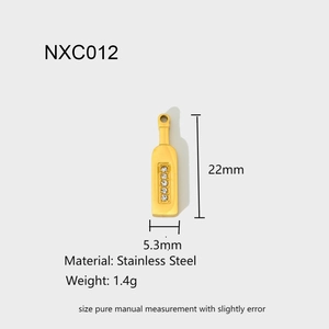 Detail view of gold wine bottle pendant with zircon inlays showing 22mm x 5.3mm size