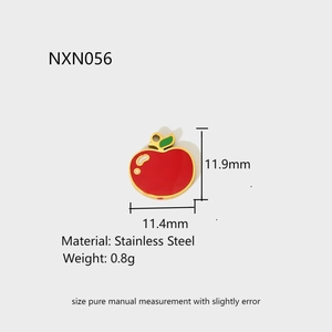 Detailed macro view of a red enamel apple pendant charm made of high-quality stainless steel