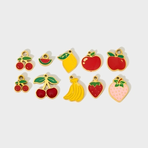 Macro detail of colorful enamel fruit charms including strawberry and lemon for DIY jewelry