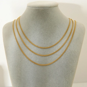 Detailed view of triple layered 18K gold plated stainless steel cable link chain necklaces