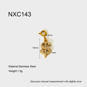 Macro detail of 18k gold plated dollar sign pendant with rhinestones and spring clasp