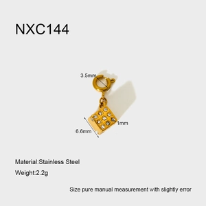 Detailed macro view of gold-plated stainless steel dice pendant with inlaid crystals