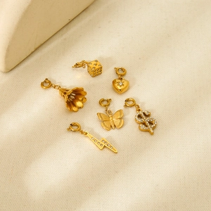 Selection of 18k gold-plated charms including dice, heart, and flower with spring clasps