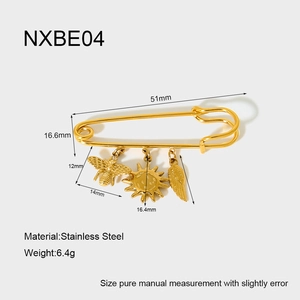 Detailed view of 18K gold-plated stainless steel brooch pin with bee, sun, and feather charms