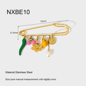 Detail view of 18K gold plated stainless steel brooch pin with assorted charm pendants