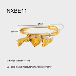 Macro detail of 18K gold plated stainless steel pin with Western themed charms