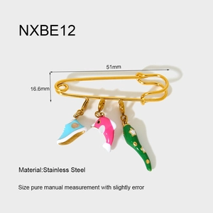 Detailed view of 18K gold plated stainless steel pin with sneaker and dolphin charms
