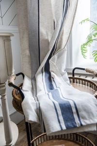 Detailed texture of navy blue striped cotton linen blend fabric curtain with natural drape