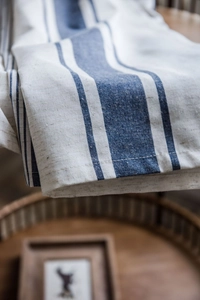 Close-up of navy blue striped cotton linen fabric texture with clean stitched edges