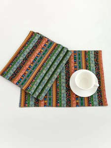 Close-up of bohemian striped placemats with ethnic patterns on a white background