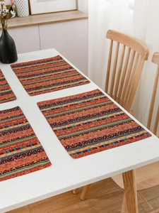 Detail of red striped bohemian cotton linen placemats set of 4 on a white dining table