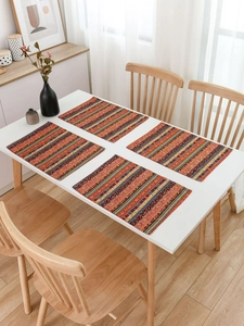 Detailed view of red striped placemats in a modern boho dining room setting