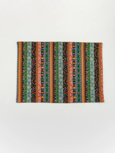 Close-up of rectangular bohemian table mat featuring colorful ethnic stripes and patterns