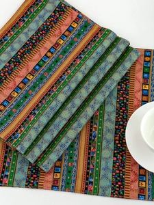 Detail of bohemian striped woven placemat showing thick multi-color fabric and texture