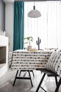 Detailed view of the wavy blue pattern on linen-texture fabric for table decor