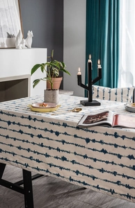 Detail shot of blue tie-dye striped pattern on white linen textured rectangular tablecloth
