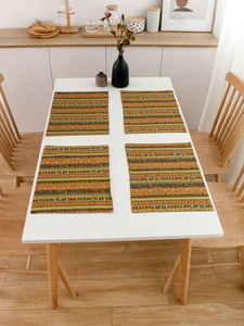 Set of 4 Bohemian striped dining placemats on white table in a warm kitchen setting