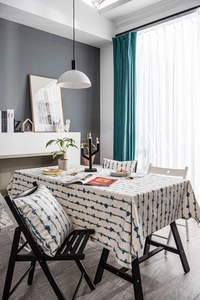 Close-up of blue vertical wavy striped tablecloth with detailed faux linen texture