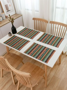 Close-up of Bohemian striped table mats with ethnic geometric patterns on a white table