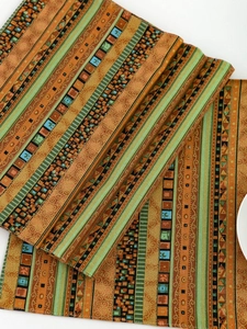 Detail view of thick yellow striped table mat showing vintage ethnic woven pattern texture
