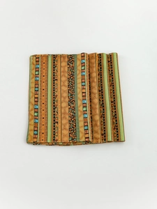 Detail of bohemian stripe placemat showing colorful geometric patterns and fine stitching
