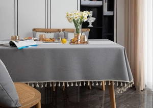Close-up of gray faux linen tablecloth with water wave jacquard and white fringe tassels