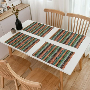 Set of 4 Bohemian striped dining placemats on a white table with a minimalist vase