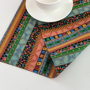 Bohemian striped table runner with colorful ethnic geometric patterns on white background