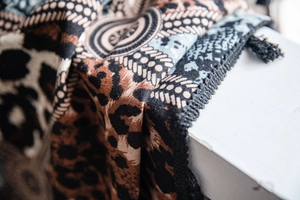 Close-up of leopard and geometric print cotton linen curtain fabric with detailed stitching