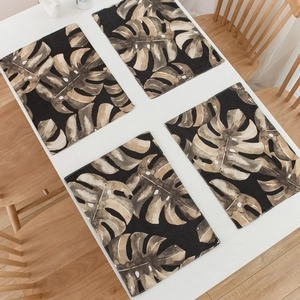 Set of 4 tropical monstera leaf placemats with a vintage aesthetic on white table