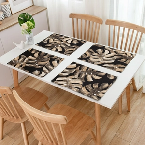 Set of 4 tropical monstera leaf placemats on white table with Nordic style decor