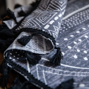 Bohemian black and white geometric print curtain with tassels and woven texture