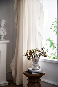 Detailed close-up of cream cotton linen curtain featuring elegant French ruffle edges