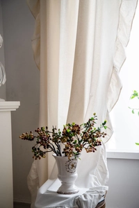 Detailed texture of French ruffle edge curtains in cream white linen blend fabric