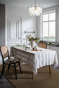 Detail of French vintage lace tablecloth featuring elegant hollowed-out floral embroidery
