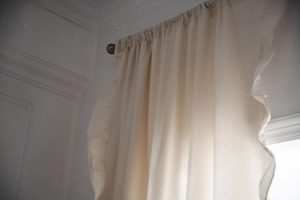 Close-up of white French style ruffle curtains with textured cotton linen fabric detail